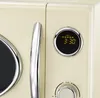 Close-up view of a cream-colored microwave oven's door and control panel. Podgląd zdjęcia produktu
