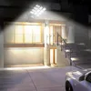 A bright LED solar street light illuminates the exterior of a modern house at night, highlighting the garage and entrance stairs. Voir les images du produit