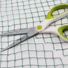 A pair of scissors is shown cutting through a green net. Podgląd zdjęcia produktu
