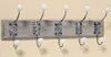 A wall-mounted coat rack with five hooks. Produktbild-Vorschau