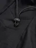 A close-up view of a black fabric item with a drawstring and toggle. Náhled obrázku produktu