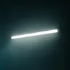 A long, white LED light fixture mounted on a dark wall. Náhľad obrázku produktu
