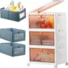 A collage of storage containers, including a fabric bin filled with stuffed animals and a multi-tiered plastic cabinet with transparent orange doors. Anteprima dell’immagine prodotto