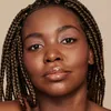 A close-up portrait of a woman's face, focusing on her makeup and braided hair. Produktbild-Vorschau