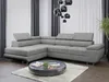 A modern living room with a grey sectional sofa, a dark coffee table, and curtains.