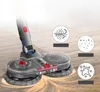 A vacuum cleaner attachment with rotating mop heads on a wooden floor, with illustrative icons showing dust and liquid. Produktbild-Vorschau