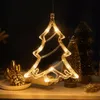 A lit-up Christmas tree decoration hangs in front of other Christmas tree decorations. Anteprima dell’immagine prodotto