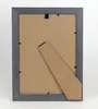 The back of a gray picture frame with a brown backing and a stand. Produktbild-Vorschau