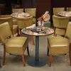 A bistro table and chairs set in an outdoor cafe setting. Produktbild-Vorschau