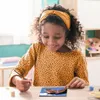 A young girl is painting a picture of a horse. Anteprima dell’immagine prodotto