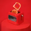 A red toaster with two slices of toast, one of which is popping out and covered in jam, against a red background. Voir les images du produit