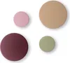 Four circular wall hooks in different colors arranged on a white background. Produktbild-Vorschau
