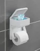 A white toilet paper holder with a compartment for wet wipes is mounted on a gray tiled wall. Produktbild-Vorschau