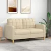 A cream-colored two-seater sofa is shown in a living room setting with two framed pictures on the wall and a plant in the background. Produktbild-Vorschau