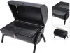 A black barrel-shaped grill with its lid open, showing the cooking grates inside. It is supported by two legs. Produktbild-Vorschau