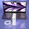 A laptop and its power adapter are shown on a reflective surface. Podgląd zdjęcia produktu
