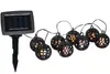 A solar-powered string of lights with 8 lantern-shaped bulbs and a solar panel stake. Produktbild-Vorschau