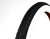 A close-up of a bicycle tire with a white sidewall and black tread. Anteprima dell’immagine prodotto