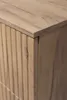 A close-up view of the corner of a wooden cabinet with a ribbed texture on the side and a smooth top. Produktbild-Vorschau