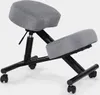 A gray and black ergonomic kneeling chair with wheels, shown against a white background. Produktbild-Vorschau