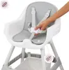 A hand is shown adjusting the harness of a high chair. Podgląd zdjęcia produktu