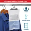 A desiccant bag hanging on a clothes rail next to shirts on hangers. Produktbild-Vorschau