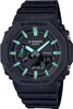 A black G-Shock watch with green accents is shown from a front-facing angle against a black background. Náhled obrázku produktu
