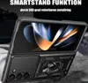 A black phone case with a built-in ring holder and camera cover is shown, with a portion of a phone screen displaying abstract graphics. Produktbild-Vorschau