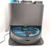 A robot vacuum cleaner docked in its charging station. Produktbild-Vorschau