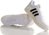 A pair of white Adidas sneakers with black stripes and a cream-colored sole, shown from a slightly elevated angle against a white background. Anteprima dell’immagine prodotto