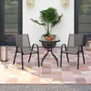 A patio set with two chairs and a table on a tiled patio. Voir les images du produit