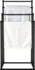 A black metal towel rack with three towels hanging on it. Produktbild-Vorschau