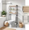 A bathroom shelf unit is shown placed over a toilet, with decorative items and towels on the shelves. Produktbild-Vorschau