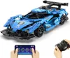 A blue remote-controlled sports car building set with a remote control and a smartphone app interface shown in the foreground. Produktbild-Vorschau