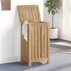 A wooden laundry hamper with its lid open, placed in a room with a plant and a rug. Podgląd zdjęcia produktu