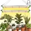 Two LED grow lights are suspended above a collection of potted houseplants. Náhľad obrázku produktu