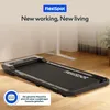 A compact treadmill is placed on a wooden floor in a room with a white wall and a plant in the background. Anteprima dell’immagine prodotto