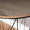 A close-up view of the edge of a round table with a wood-grain pattern and a black metal wire base. Produktbild-Vorschau