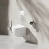 A modern bathroom setting with a wall-mounted toilet and accessories. Produktbild-Vorschau