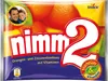 A close-up of a candy package with images of fruits and people. Podgląd zdjęcia produktu