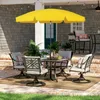 An outdoor patio scene with a yellow umbrella and patio furniture. Produktbild-Vorschau