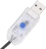 A close-up view of a USB connector with a blue button on a transparent casing. Voir les images du produit