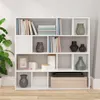 A white bookshelf filled with books and decorative items, placed in a room with a plant. Náhľad obrázku produktu