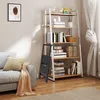 A black folding step stool is placed in front of a bookshelf in a living room setting. Voir les images du produit