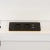 A close-up view of a black power strip with two electrical outlets and two USB ports, mounted on a white surface. Produktbild-Vorschau