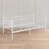 A white metal daybed is shown against a light gray and white wall and a wooden floor. Voir les images du produit