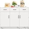 A white kitchen island with a marble-effect countertop and base, featuring three drawers and three cabinet doors. It is styled with decorative items on top, including a stack of pancakes, strawberries, a vase of flowers, and a coffee machine. Voir les images du produit