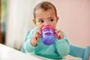 A baby sitting in a high chair drinking from a sippy cup. Voir les images du produit