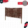 A woven willow fence section with wooden stakes. Anteprima dell’immagine prodotto