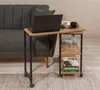 A side table with a laptop, coffee cup, and books next to a sofa. Voir les images du produit